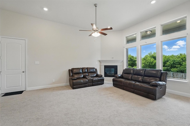 517 Fenwick Dr, Sunnyvale, TX 75182 - carpeted living area featuring baseboards, a glass covered fireplace, a ceiling fan, and recessed lighting