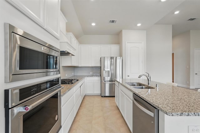 517 Fenwick Dr, Sunnyvale, TX 75182 - kitchen with stainless steel appliances, a sink, a center island with sink, backsplash, and light stone counters