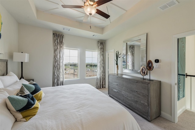 2233 Fort Bliss, Mesquite, TX 75149 - bedroom featuring a tray ceiling, light colored carpet, baseboards, and ceiling fan