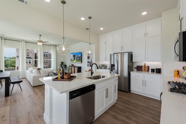 2233 Fort Bliss, Mesquite, TX 75149 - kitchen with stainless steel appliances, a sink, wood finished floors, light countertops, and recessed lighting