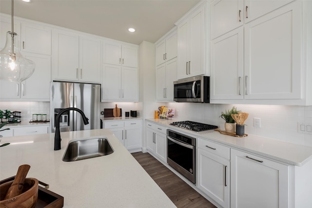 2233 Fort Bliss, Mesquite, TX 75149 - kitchen featuring appliances with stainless steel finishes, a sink, backsplash, recessed lighting, and light countertops