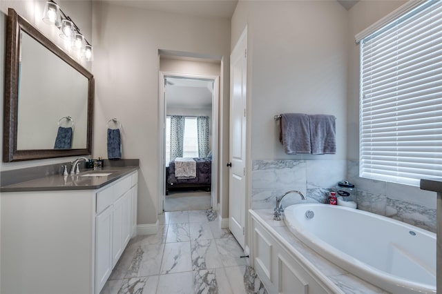1502 Wild Indigo Dr, Mansfield, TX 76063 - ensuite bathroom with marble finish flooring, vanity, a bath, and baseboards
