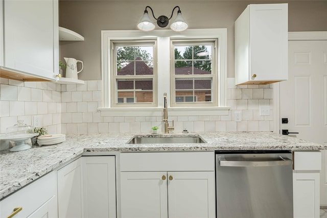 1225 Sayles Blvd, Abilene, TX 79605 - kitchen with stainless steel dishwasher, a sink, open shelves, white cabinets, and tasteful backsplash