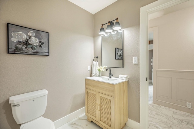 1225 Sayles Blvd, Abilene, TX 79605 - bathroom featuring marble look tile flooring, vanity, toilet, and baseboards
