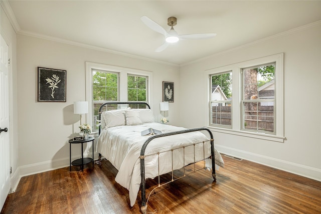 1225 Sayles Blvd, Abilene, TX 79605 - bedroom with baseboards, dark wood-style floors, multiple windows, ornamental molding, and a ceiling fan
