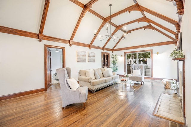 1225 Sayles Blvd, Abilene, TX 79605 - living room with high vaulted ceiling, baseboards, wood finished floors, and a chandelier