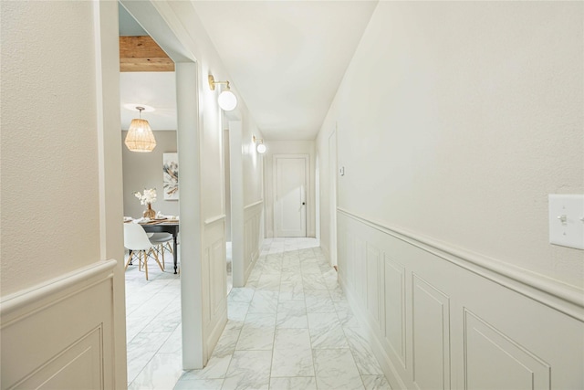 1225 Sayles Blvd, Abilene, TX 79605 - hall with light marble finish flooring, a decorative wall, and wainscoting