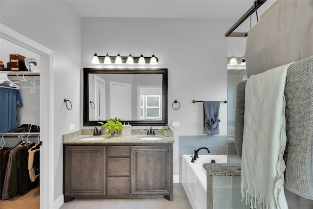 1621 Whispering Trail Dr, Waxahachie, TX 75165 - full bathroom featuring a bath, tile patterned floors, double vanity, and a spacious closet