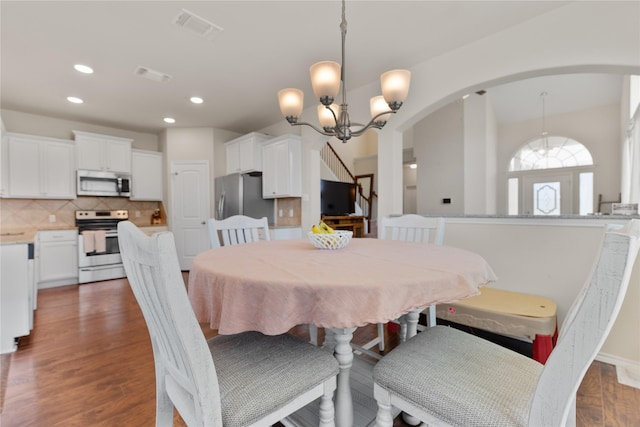 11212 Haviture Way, Waco, TX 76708 - dining area with arched walkways, recessed lighting, a chandelier, and wood finished floors