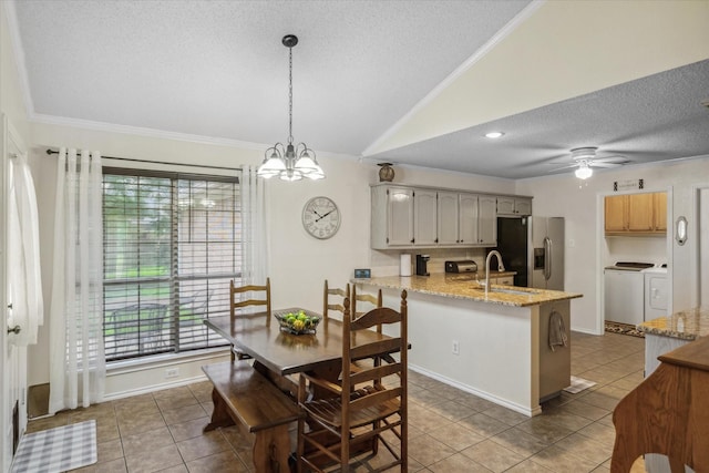 221 Country View Ln, Crandall, TX 75114 - dining area featuring washer and dryer, a textured ceiling, ornamental molding, tile patterned floors, and plenty of natural light