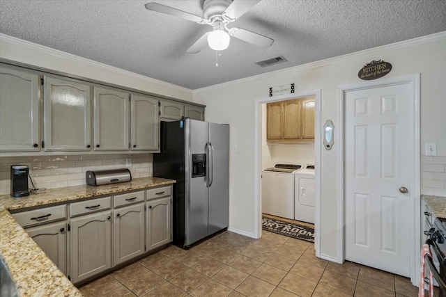 221 Country View Ln, Crandall, TX 75114 - kitchen featuring stainless steel fridge, washer and dryer, a textured ceiling, decorative backsplash, and ornamental molding
