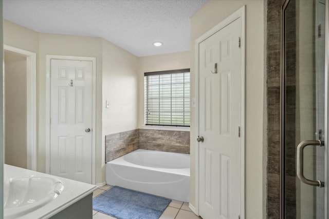221 Country View Ln, Crandall, TX 75114 - bathroom with vanity, tile patterned floors, a garden tub, a shower stall, and a textured ceiling