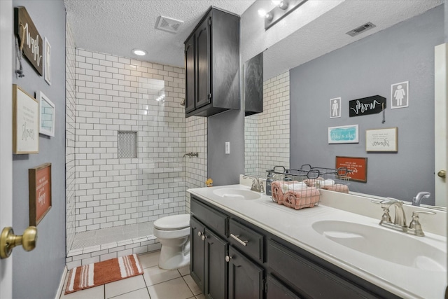 221 Country View Ln, Crandall, TX 75114 - full bath with a textured ceiling, double vanity, toilet, tile patterned flooring, and a tile shower