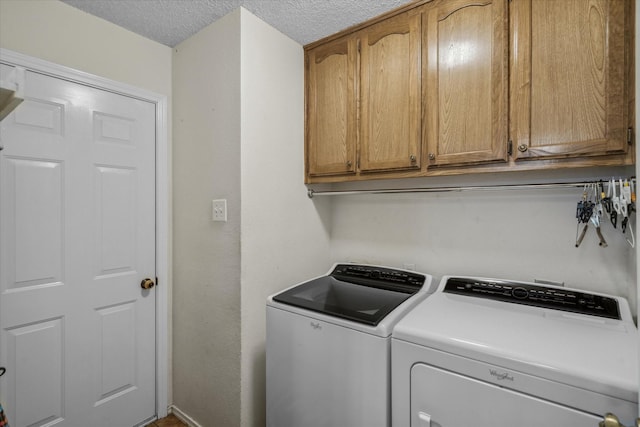 221 Country View Ln, Crandall, TX 75114 - laundry area featuring cabinet space, washer and clothes dryer, and a textured ceiling