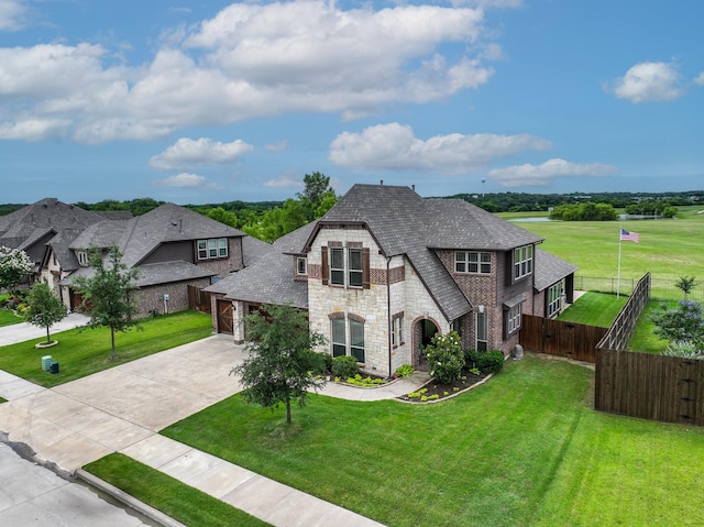 4705 Stillhouse Hollow Ln, Argyle, TX 76226 - french country style house featuring stone siding, driveway, a shingled roof, and an attached garage