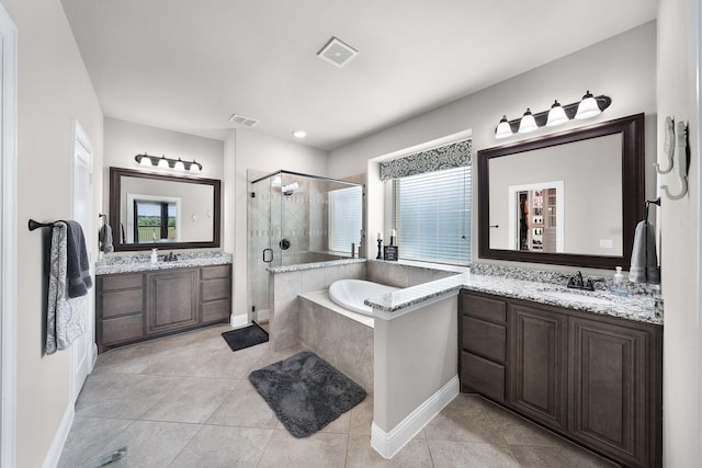 4705 Stillhouse Hollow Ln, Argyle, TX 76226 - bathroom featuring a stall shower, a bath, two vanities, tile patterned flooring, and baseboards