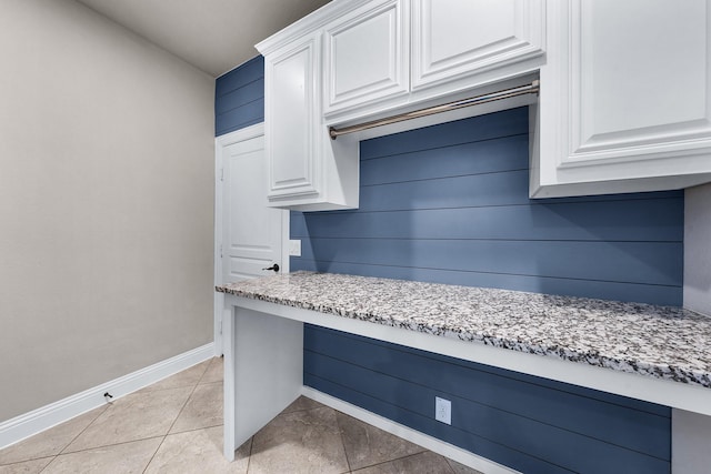 4705 Stillhouse Hollow Ln, Argyle, TX 76226 - kitchen with baseboards, white cabinetry, light tile patterned floors, and light stone countertops