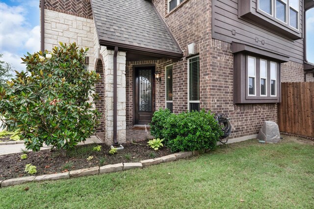 4705 Stillhouse Hollow Ln, Argyle, TX 76226 - view of exterior entry with brick siding and a shingled roof