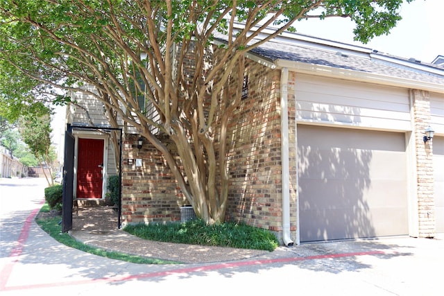 5616 Preston Oaks Rd Unit 508, Dallas, TX 75254 - view of property exterior featuring brick siding and a garage