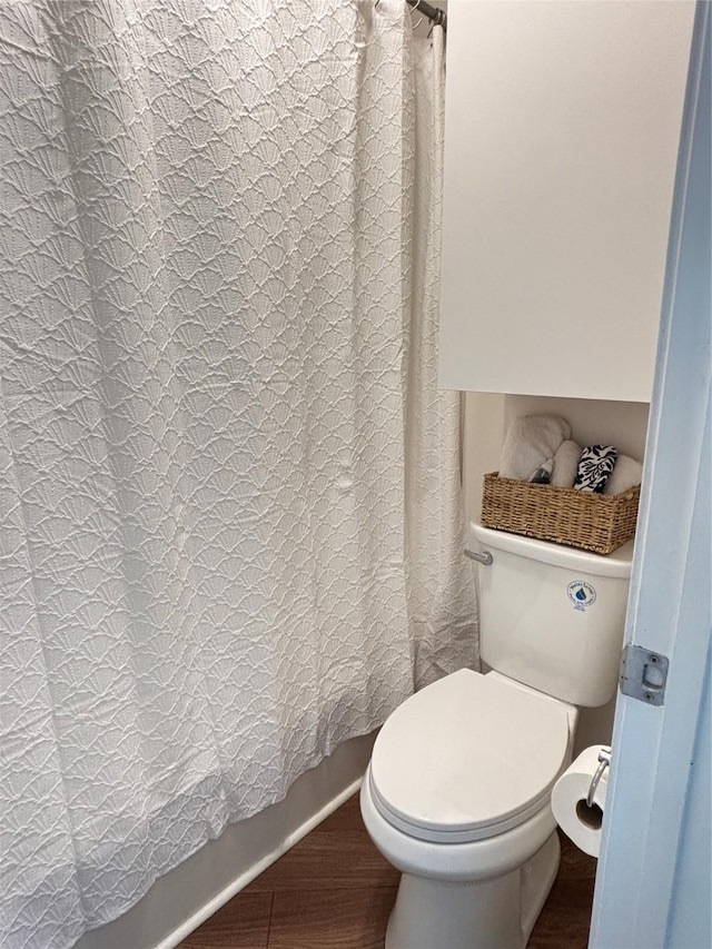 5616 Preston Oaks Rd Unit 508, Dallas, TX 75254 - bathroom with wood finished floors, toilet, and shower / tub combo