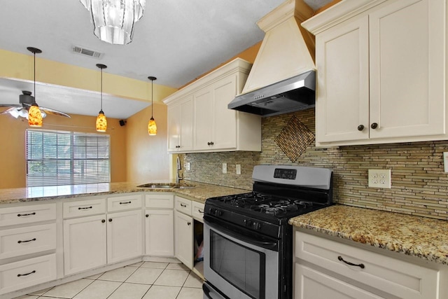 3829 Willing Ave, Fort Worth, TX 76110 - kitchen with gas range, premium range hood, ceiling fan, a sink, and a peninsula