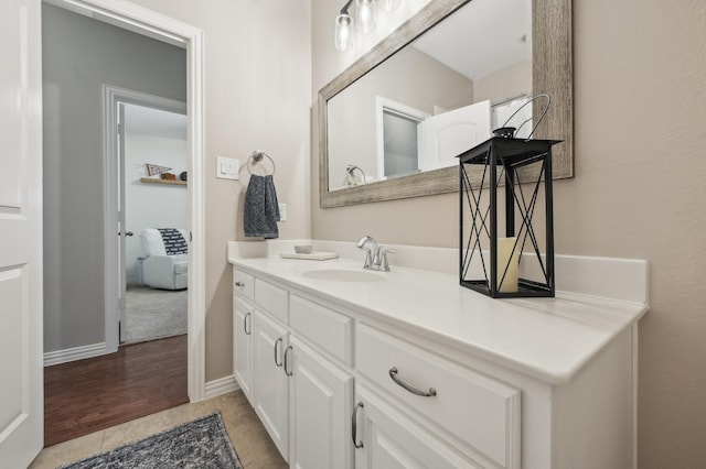 5104 Fringetree Dr, Mckinney, TX 75071 - bathroom with vanity, wood finished floors, and baseboards