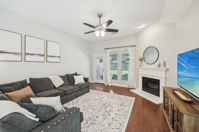 5104 Fringetree Dr, Mckinney, TX 75071 - living area with a ceiling fan, a fireplace with raised hearth, and dark wood-style floors