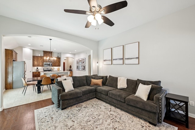 5104 Fringetree Dr, Mckinney, TX 75071 - living room featuring arched walkways, wood-type flooring, ceiling fan, recessed lighting, and a chandelier