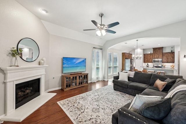 5104 Fringetree Dr, Mckinney, TX 75071 - living area featuring arched walkways, a chandelier, a ceiling fan, dark wood-style floors, and baseboards