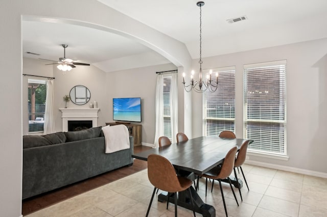 5104 Fringetree Dr, Mckinney, TX 75071 - dining room featuring a chandelier, light tile patterned flooring, a fireplace, baseboards, and ceiling fan