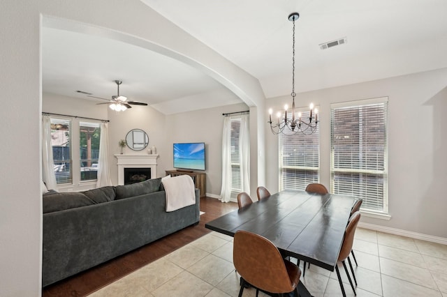 5104 Fringetree Dr, Mckinney, TX 75071 - dining room featuring a chandelier, light tile patterned floors, ceiling fan, baseboards, and a fireplace