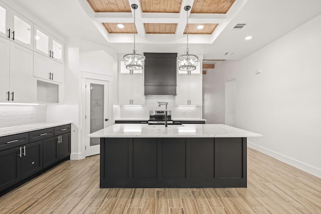 3008 25th St, Fort Worth, TX 76106 - kitchen with coffered ceiling, light wood-type flooring, decorative backsplash, a sink, and white cabinetry