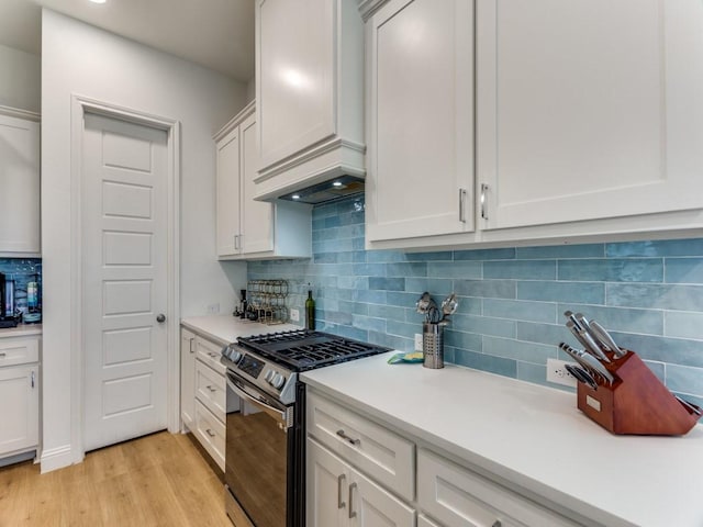 6656 Windfall Dr, Fort Worth, TX 76135 - kitchen with stainless steel range with gas stovetop, light countertops, custom exhaust hood, light wood-style floors, and backsplash