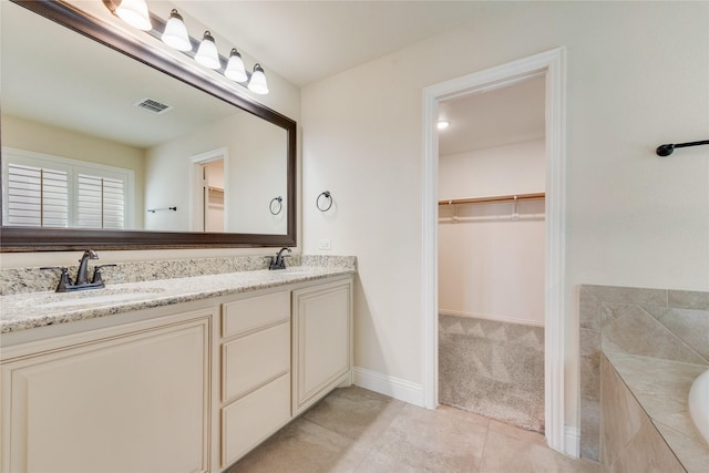 1207 Glasbury Glen Way, Forney, TX 75126 - full bath with double vanity, tile patterned floors, a bath, a walk in closet, and baseboards
