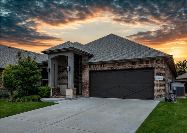 1225 Lynn Dr, Arlington, TX 76002 - french country home with brick siding, an attached garage, driveway, and a front lawn