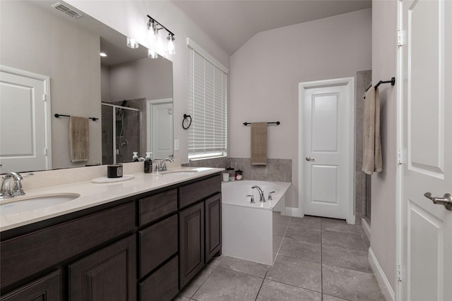 1225 Lynn Dr, Arlington, TX 76002 - bathroom with a stall shower, tile patterned floors, double vanity, a bath, and lofted ceiling