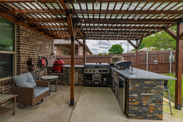 1225 Lynn Dr, Arlington, TX 76002 - fenced backyard featuring exterior kitchen, a pergola, and a patio area