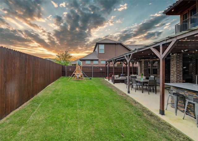 1225 Lynn Dr, Arlington, TX 76002 - fenced backyard featuring an outdoor living space, a patio, and a playground