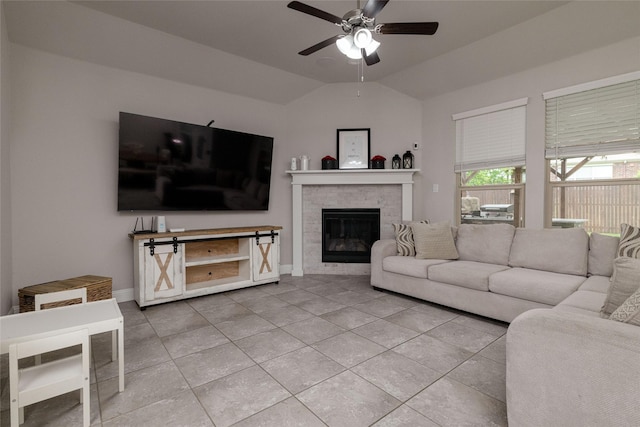 1225 Lynn Dr, Arlington, TX 76002 - living area featuring ceiling fan, light tile patterned floors, a glass covered fireplace, and lofted ceiling