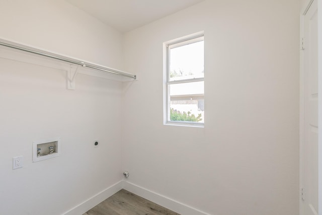 7205 Coventry Cir, North Richland Hills, TX 76182 - washroom with baseboards, hookup for a washing machine, electric dryer hookup, and light wood-style flooring