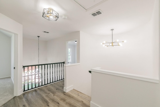 7205 Coventry Cir, North Richland Hills, TX 76182 - hallway featuring attic access, wood finished floors, a chandelier, and baseboards