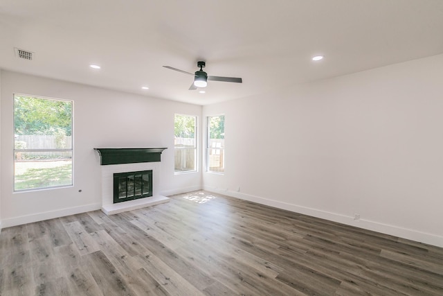 7205 Coventry Cir, North Richland Hills, TX 76182 - unfurnished living room featuring recessed lighting, wood finished floors, baseboards, a ceiling fan, and a glass covered fireplace