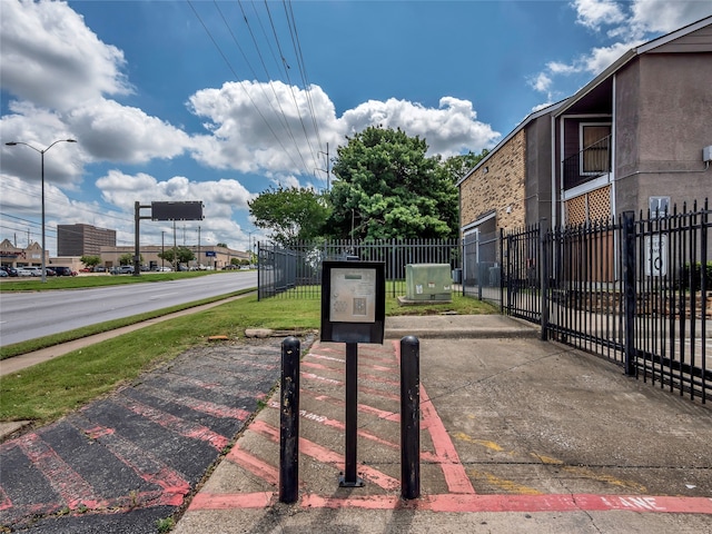 9170 Forest Ln Unit 228, Dallas, TX 75243 - view of asphalt road featuring sidewalks and street lighting