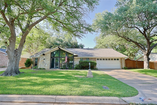 312 W Pleasantview Dr, Hurst, TX 76054 - view of front of home featuring a garage, driveway, and stone siding
