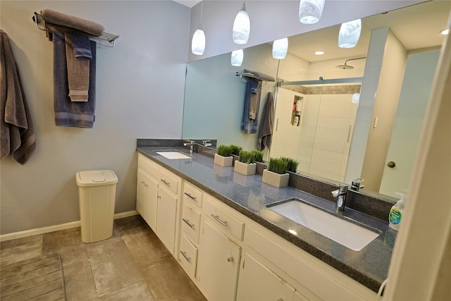 312 W Pleasantview Dr, Hurst, TX 76054 - bathroom featuring double vanity, a tile shower, tile patterned floors, baseboards, and recessed lighting