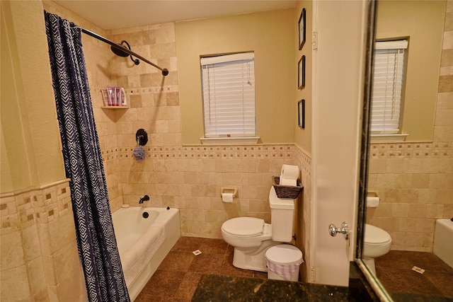 312 W Pleasantview Dr, Hurst, TX 76054 - bathroom with tile walls, toilet, tile patterned floors, shower / tub combo with curtain, and a wainscoted wall