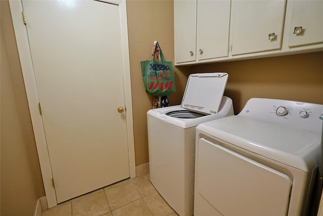 312 W Pleasantview Dr, Hurst, TX 76054 - washroom with washer and clothes dryer, cabinet space, light tile patterned floors, and baseboards