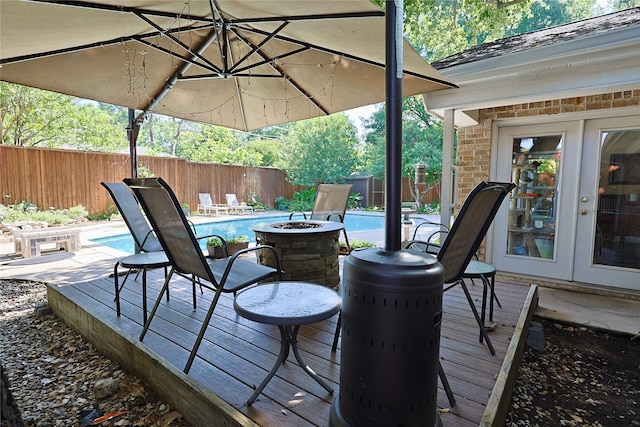 312 W Pleasantview Dr, Hurst, TX 76054 - wooden terrace with french doors, a fenced backyard, and a fire pit