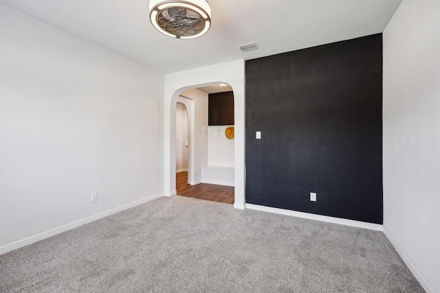 632 Dunster Ln, Saginaw, TX 76131 - empty room with carpet, arched walkways, and baseboards