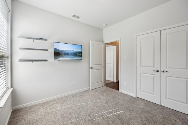 632 Dunster Ln, Saginaw, TX 76131 - unfurnished bedroom featuring carpet, baseboards, multiple windows, and a closet